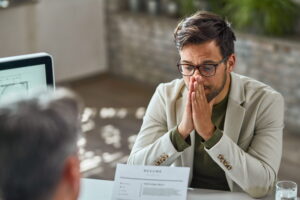 distraught young man feeling uncertain while having job interview office 1